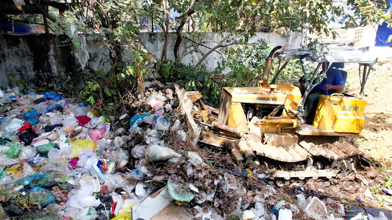 BULLDOZER PUSH THE TRASH AND COVER BY STONE DUMP TRAUCK UNLOAD
