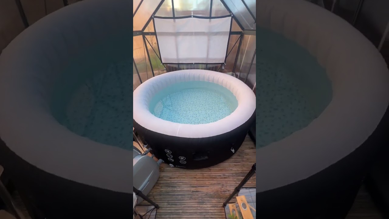 Woman is giving a tour of her hut tub greenhouse!