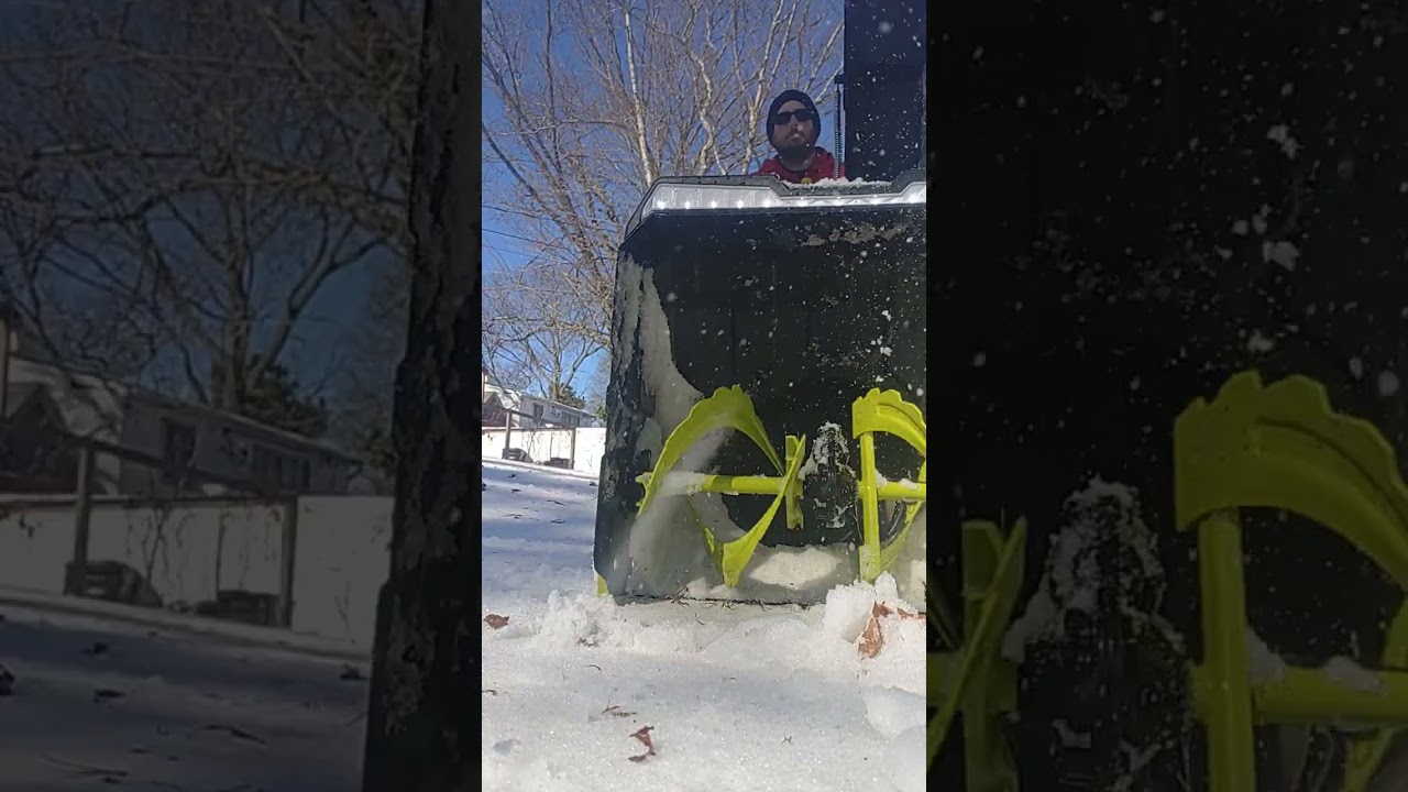Snow blowing over grass