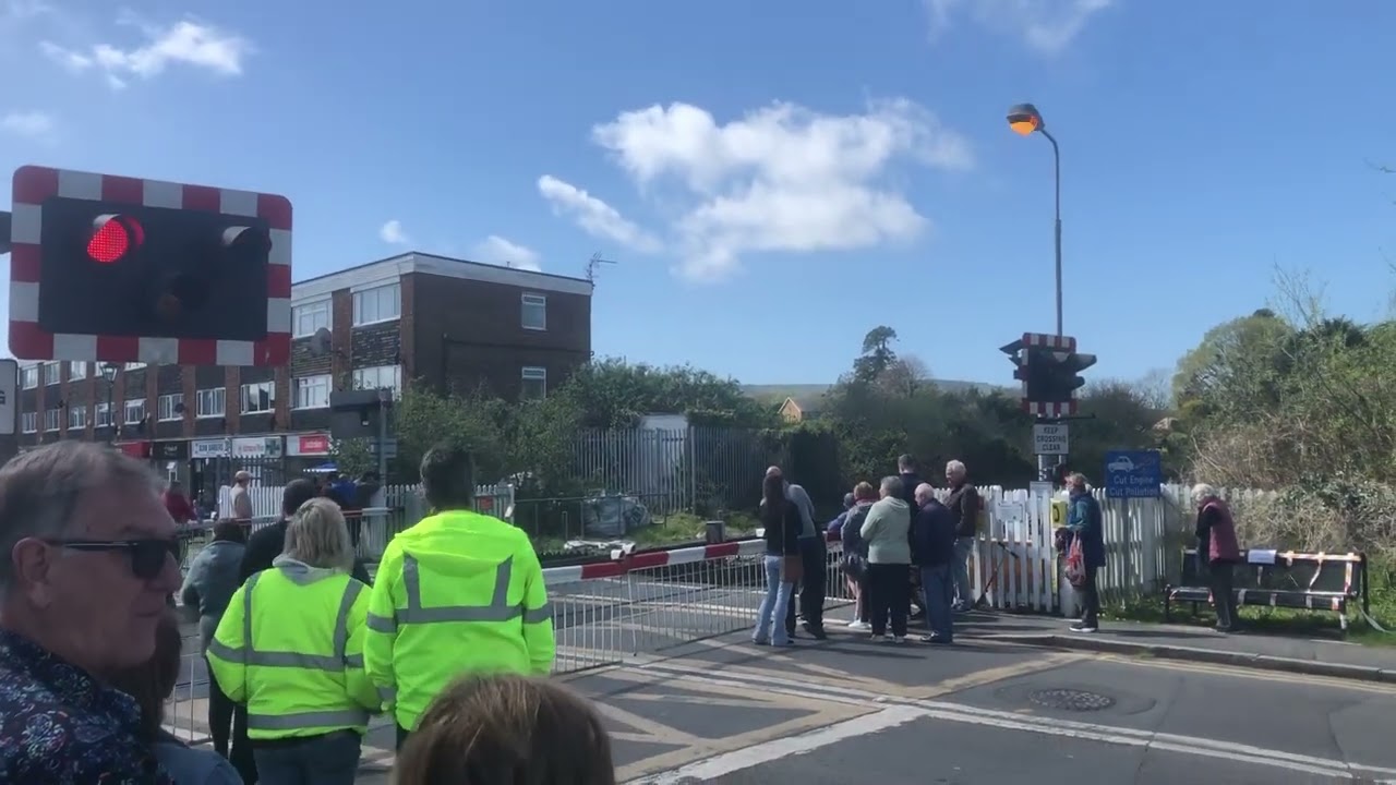 A rare steam train passes at polegate level crossing East Sussex