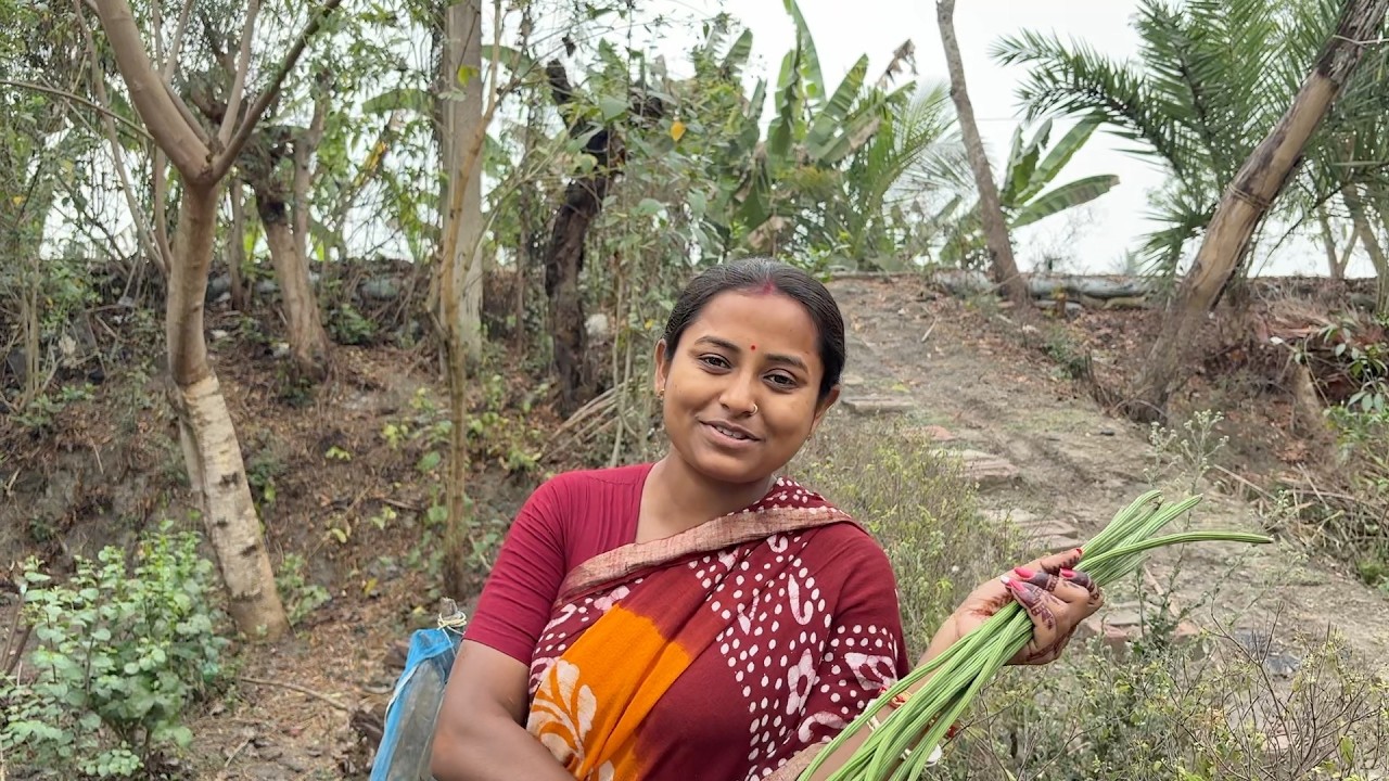 গাছ থেকে সজনে ডাটা পেড়ে পার্শে মাছ দিয়ে রান্না