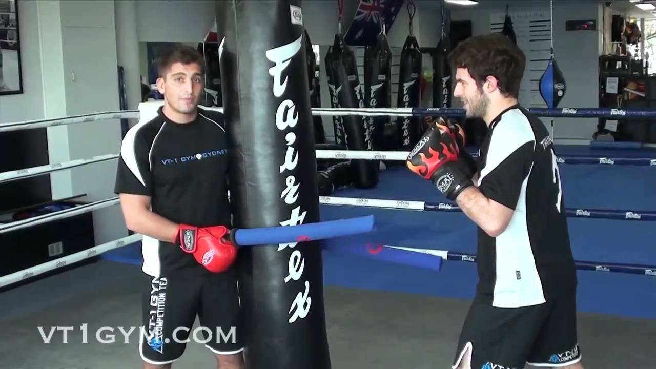 Muay Thai and MMA - Slip, Bob and Weave Drill w/ Heavy Bag and Batons