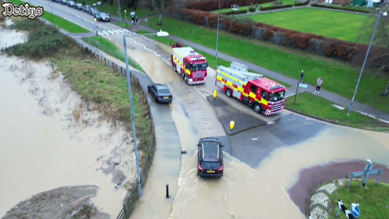 Corby Northamptonshire flooded roads, cars going for it.