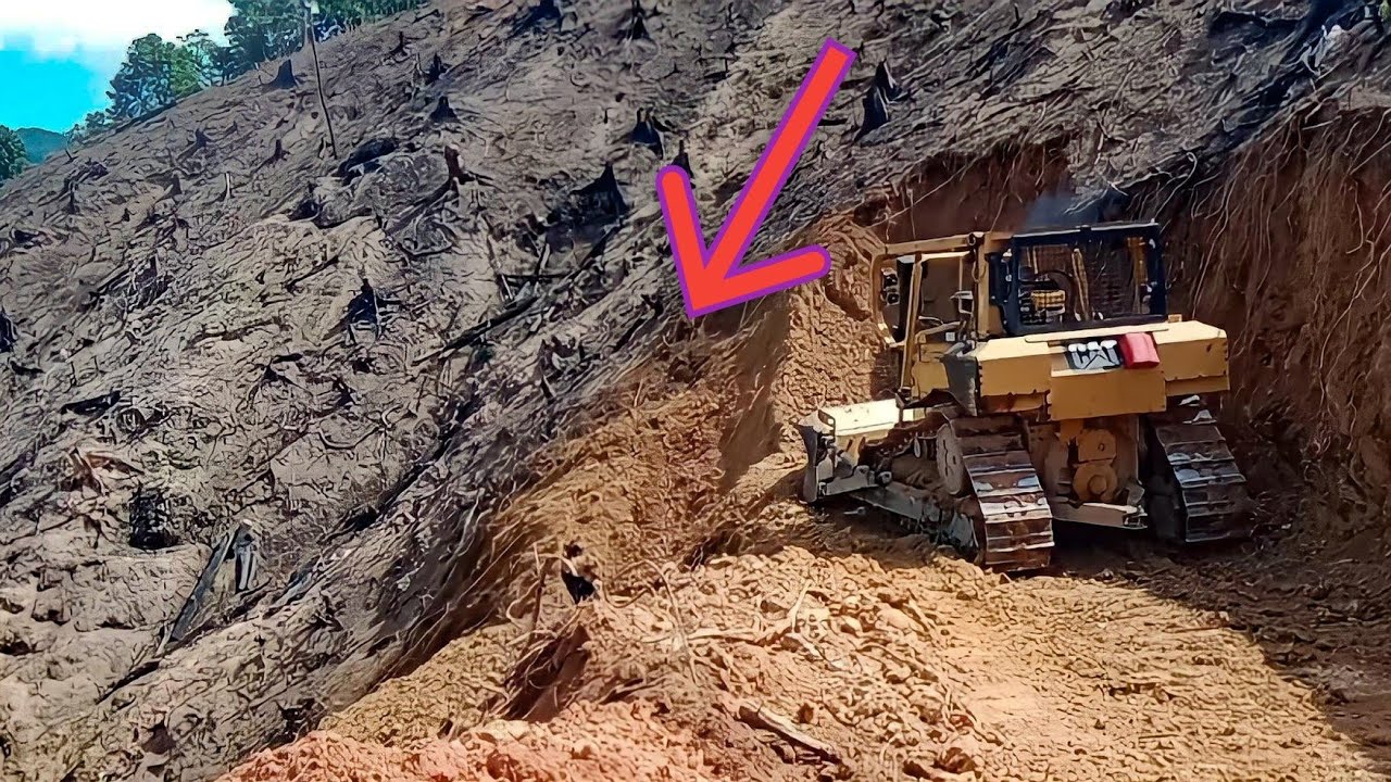 Very extreme paving the way on the edge of the abyss CAT BULLDOZER D6R XL does a very good job