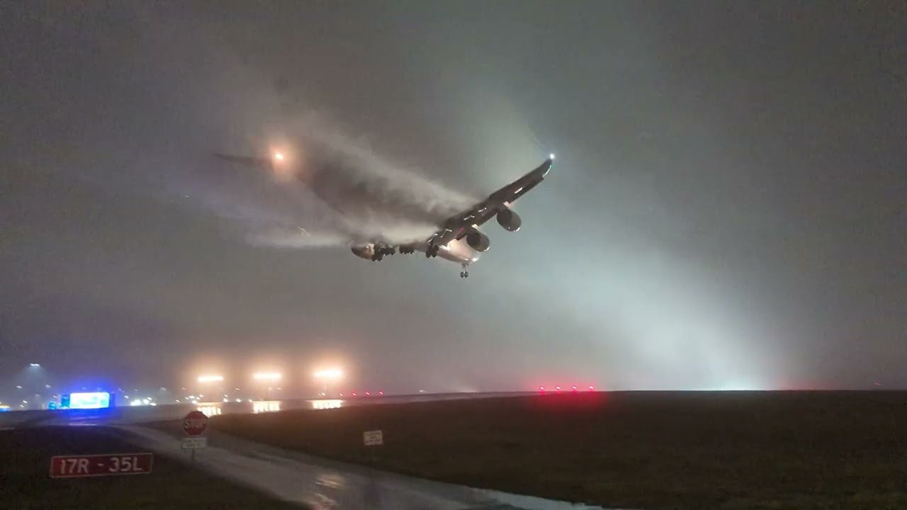 Airplane landing on runway leaves vortex trails in thick fog