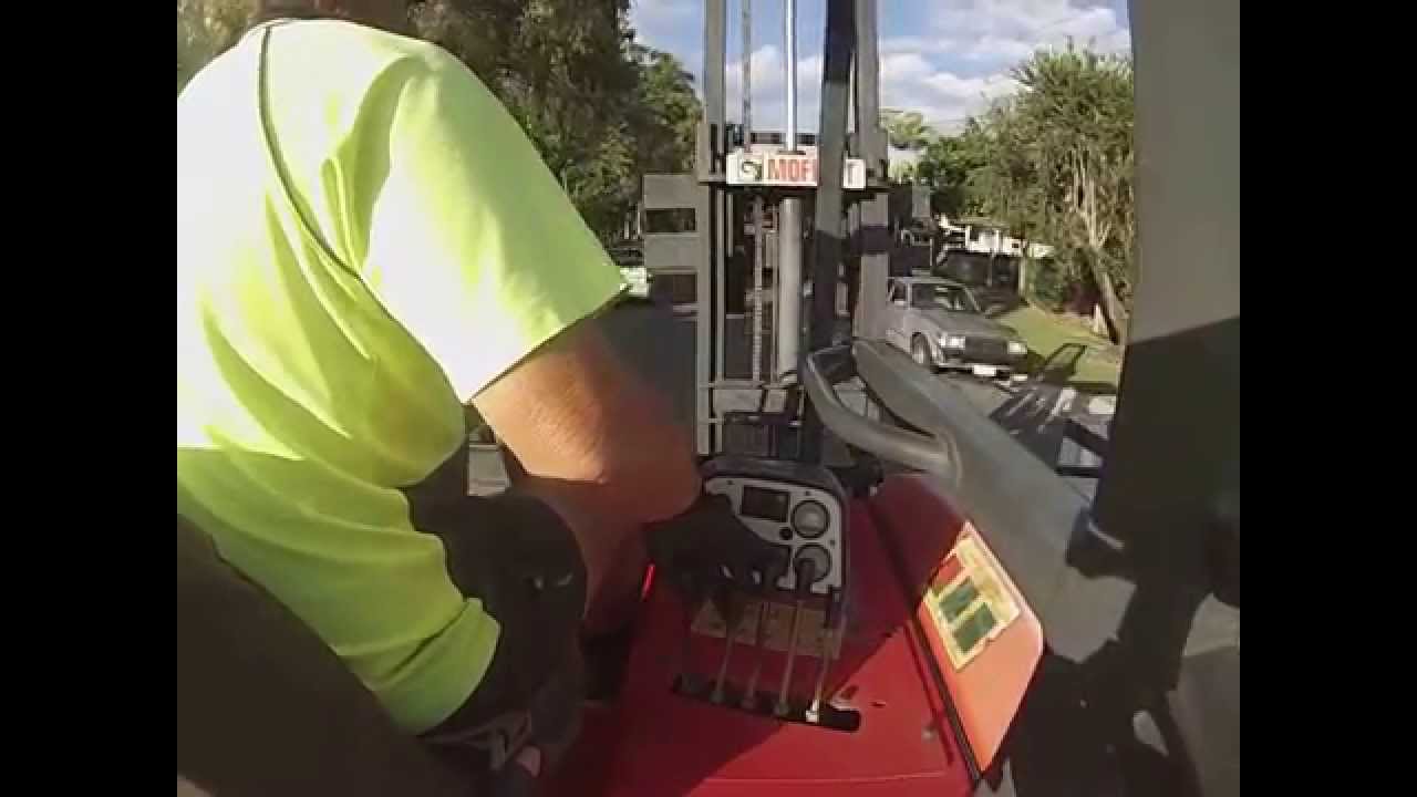 Truck being unloaded by Moffett forklift.