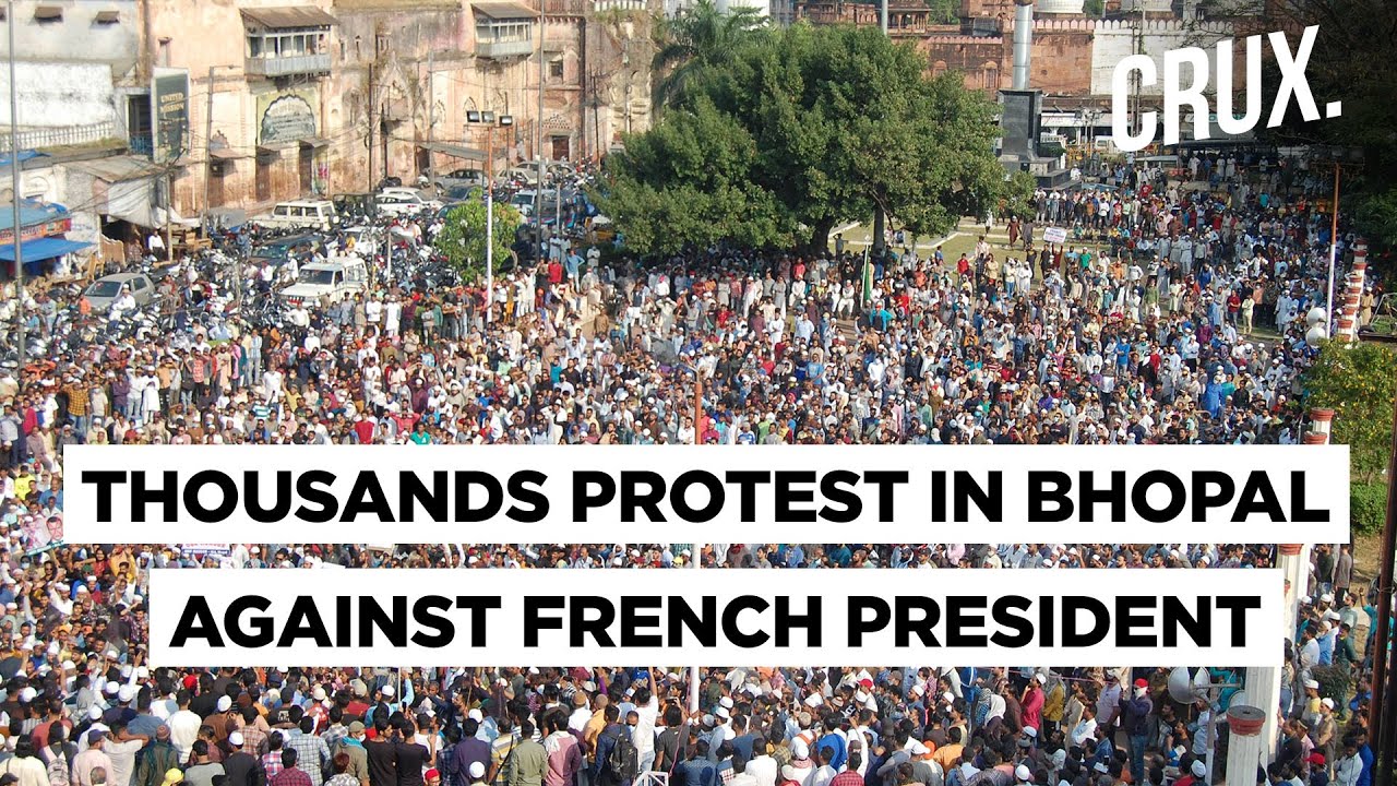Protesters Stomp On Posters of French President Emmanuel Macron Plastered On The Streets Of Mumbai