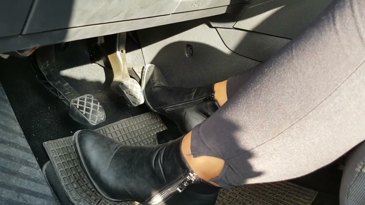 Pedal pumping revving girl in black leather ankle boots