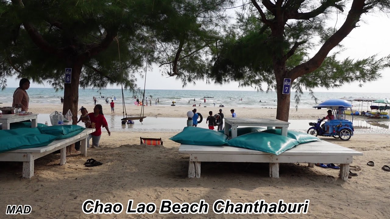 Eating Dried Squid on The Beach, Chao Lao Beach Chanthaburi Thailand.