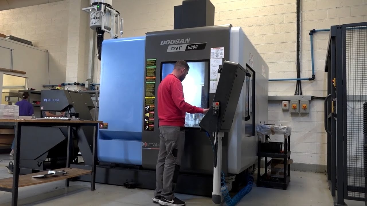 Mills CNC install 3 x 5 axis machines all fed by one industrial robot