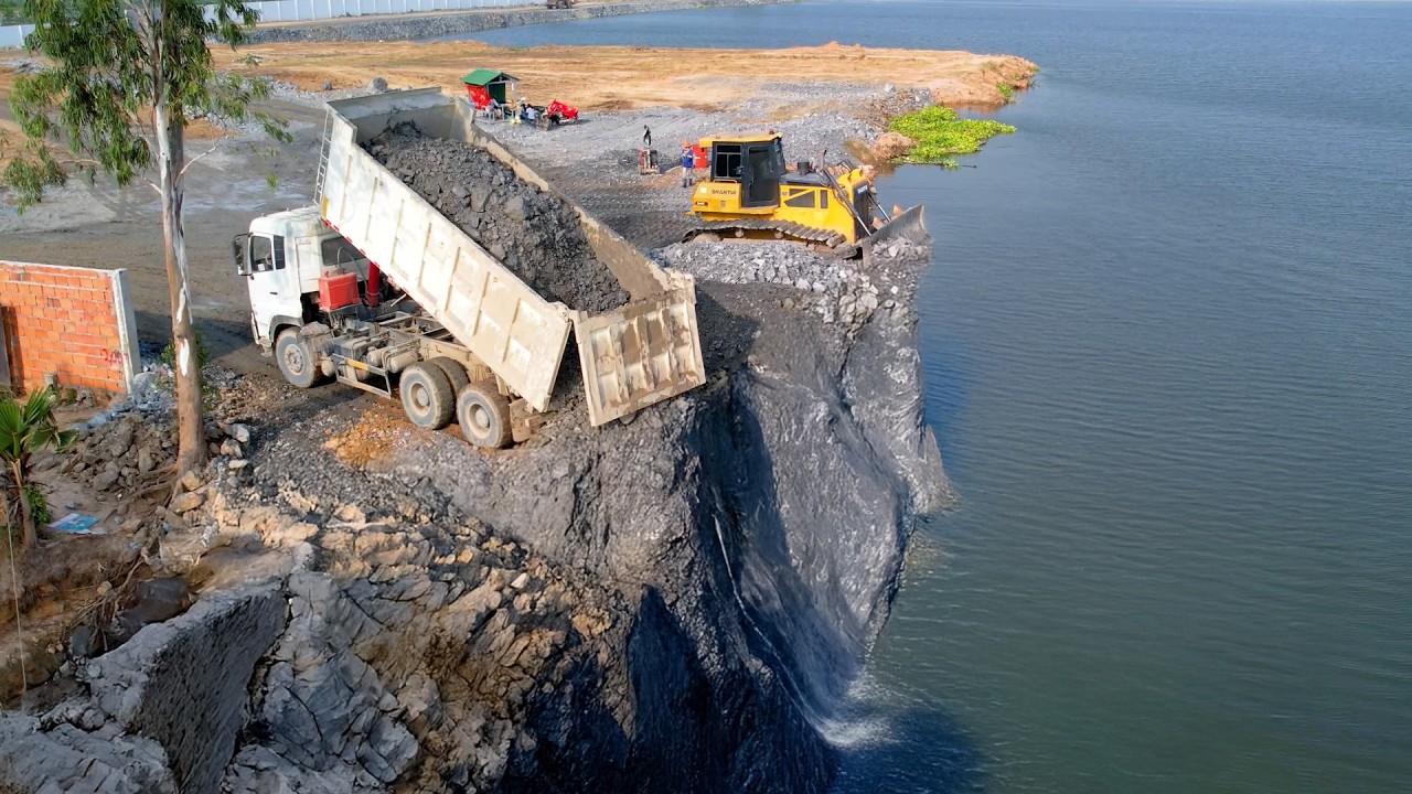 Showing Action by Bulldozer Pushing deep water dirty pond