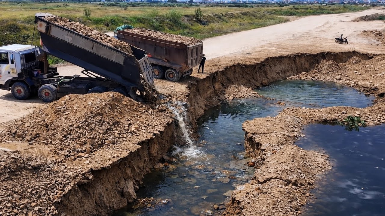 Huge Dump Trucks Unloading Rock Bury Crack And Sink Land With Komatsu Dozer