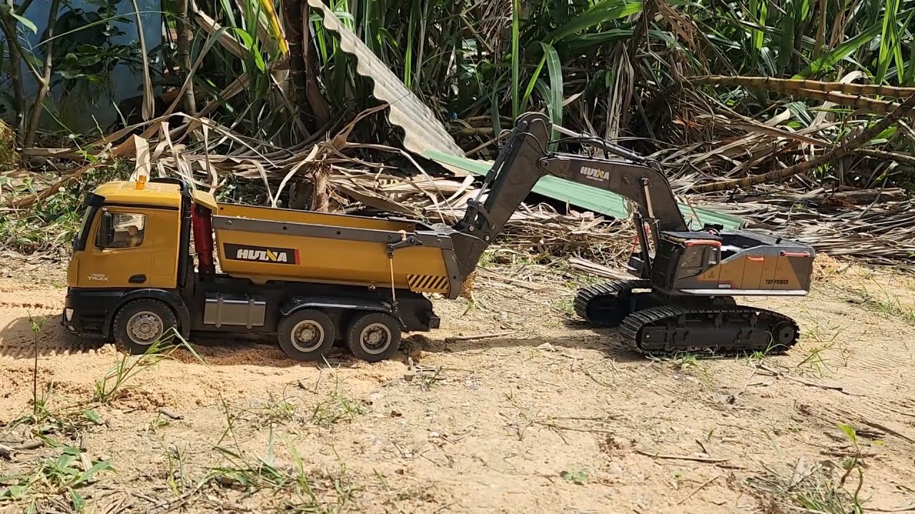 RC Excavator Loading Dump Truck in a Realistic Outdoor Worksite