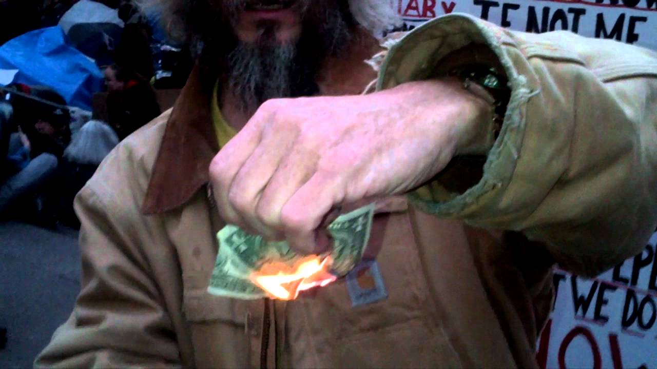 Man burning money at Occupy Wall Street