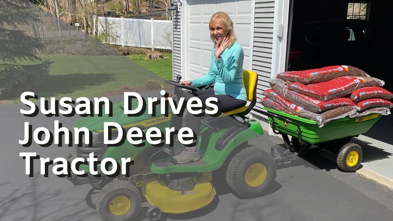 Susan Drives A John Deere 2021 S120 Lawn Tractor With Tow Behind Poly Utility Dump Cart Trailer