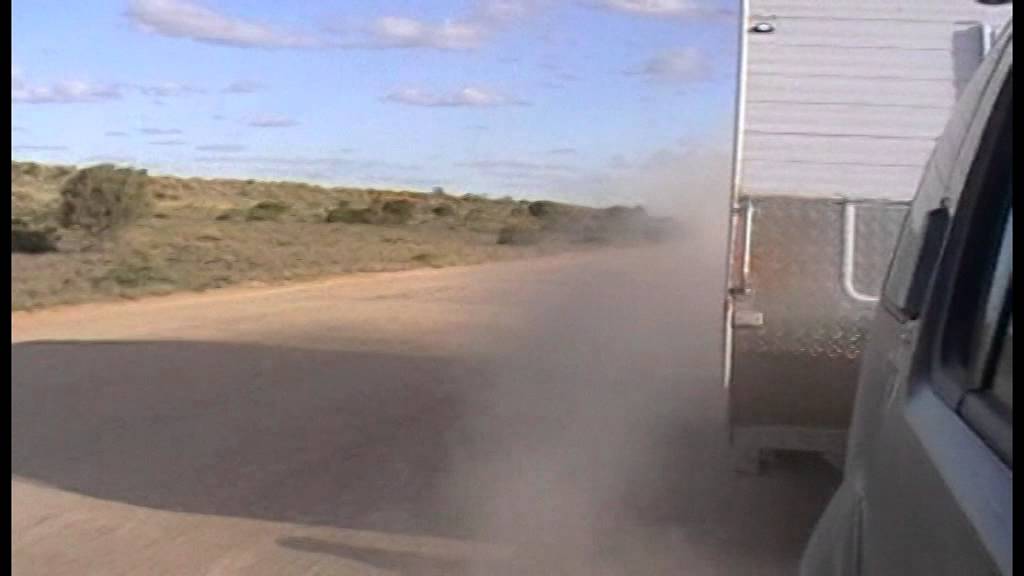 Road test single mud flap on corrugated dirt road towing off road caravan.