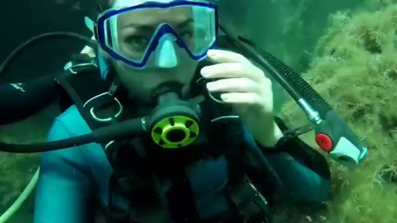 Female Diver is Diving with Neoprene Wetsuit