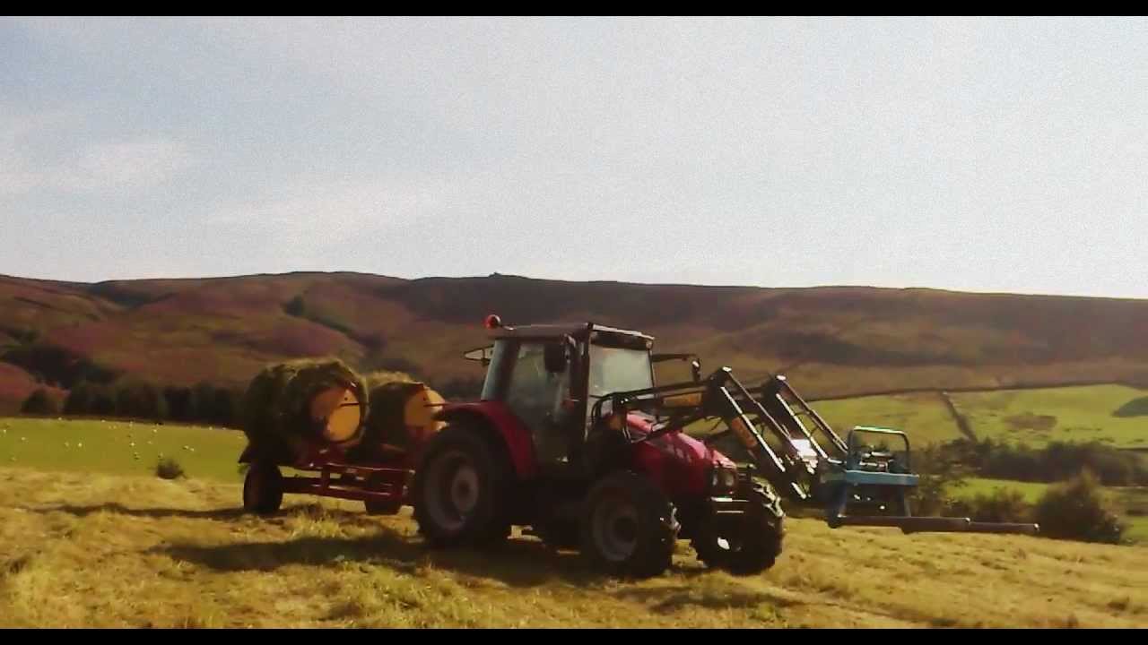 massey ferguson at work collecting bales traileyre 5455 and 6160