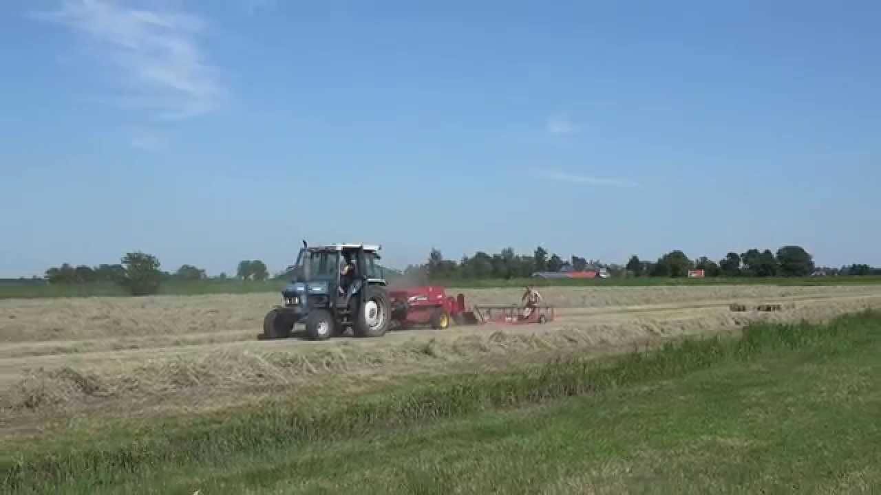 Ford 5610 and New Holland 575  baling hay.