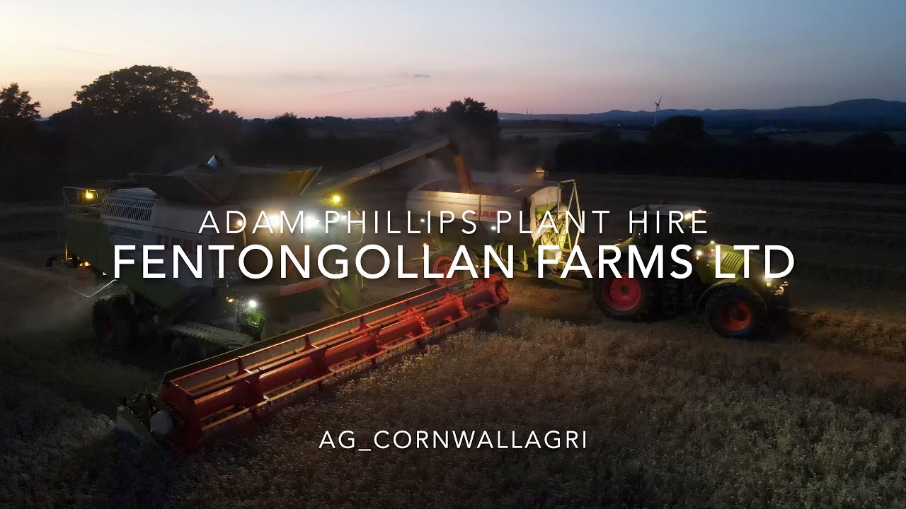 Double Claas Combines working into the night