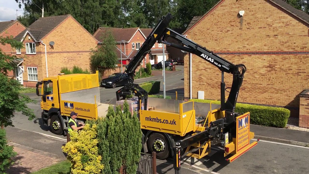 Crane grab truck bricks delivery