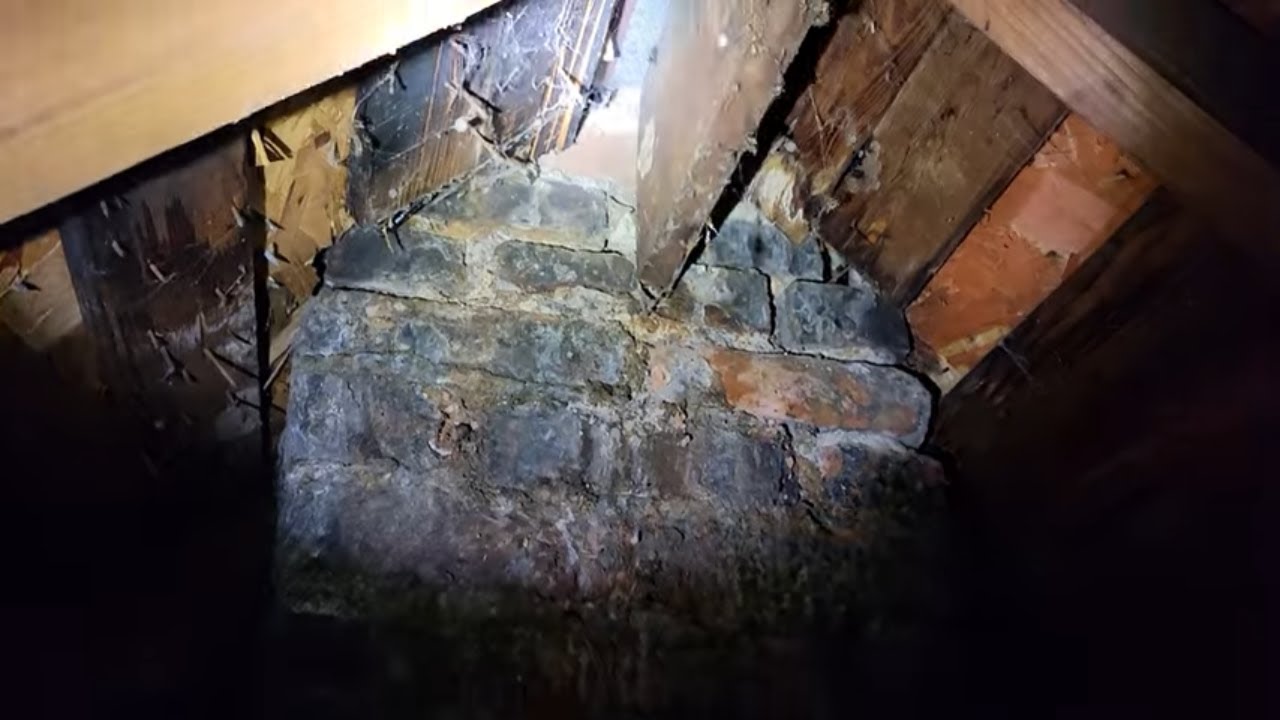 Attic inspection for a possible roof leak at the chimney.