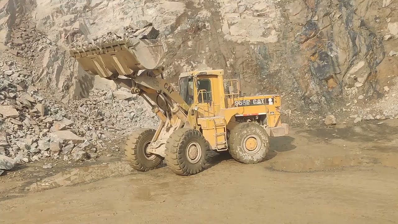 Trolley+ Caterpillar Loadar loading Stone in mountain: biggest Stone