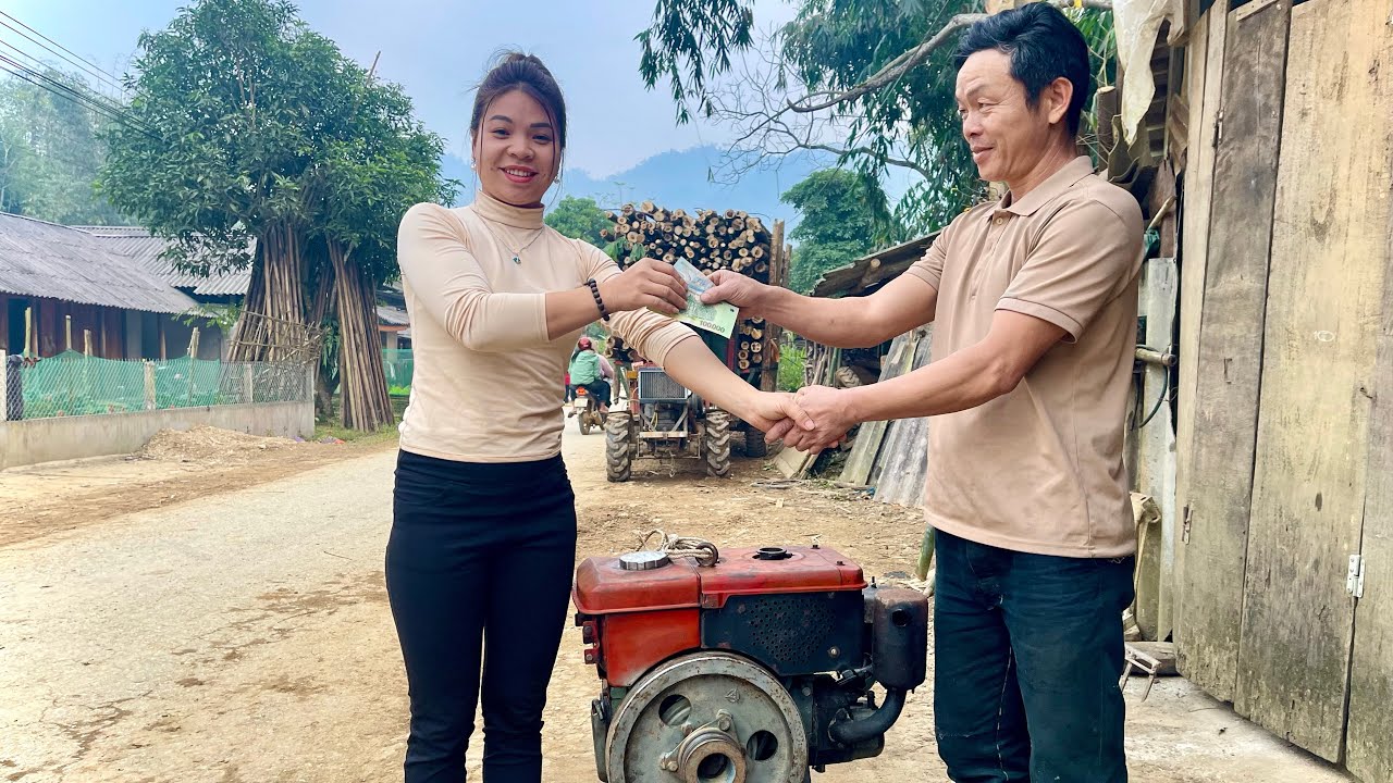 The female mechanic continues her work repairing engines for local residents.