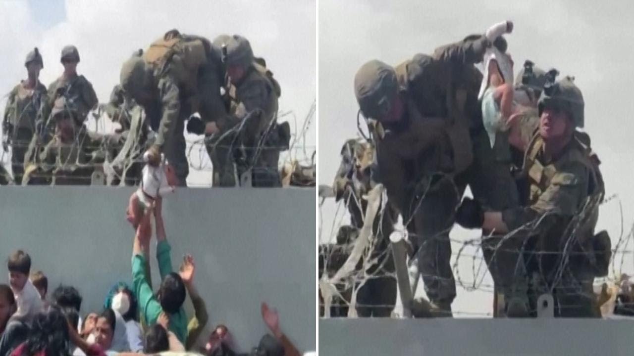 Afghanistan: Young baby passed over barbed wire fence to soldiers at airport