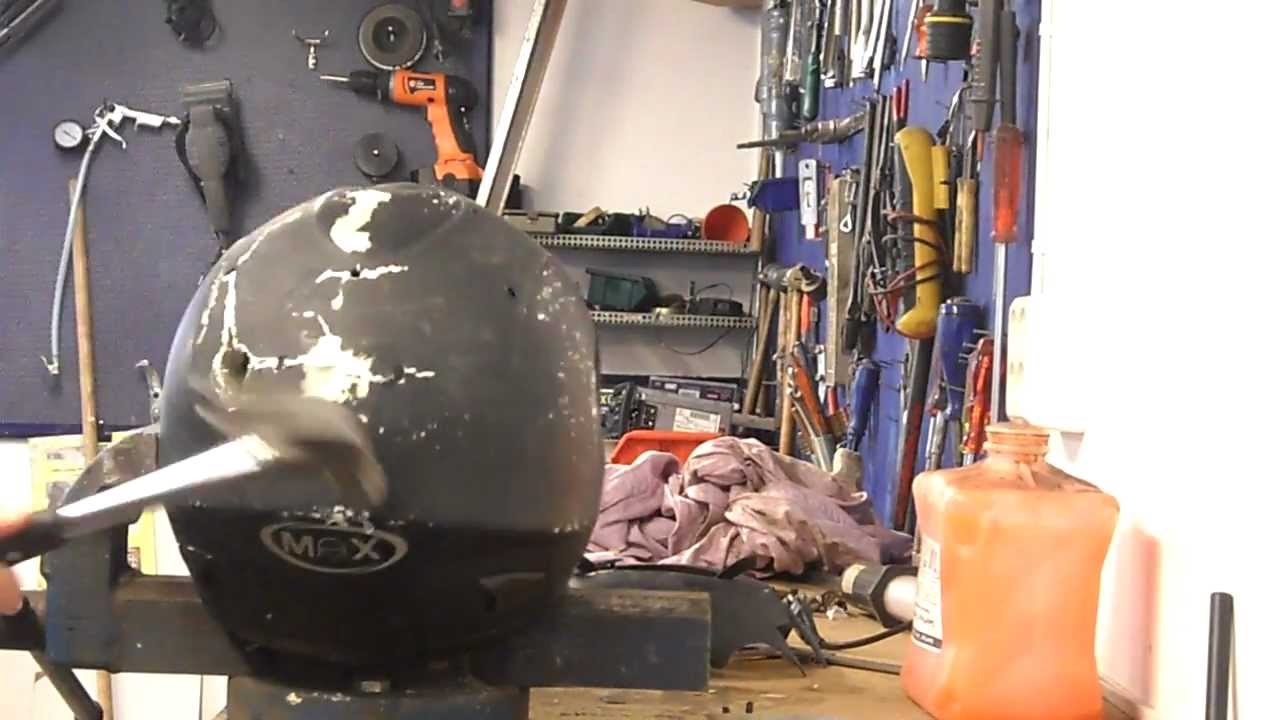 Destroying a motorcycle helmet with a hammer