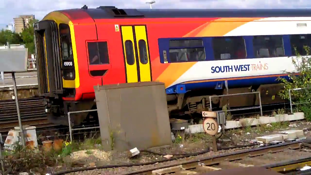 South Western Railways class 159 108 and 159 005 arrives at Clapham Junction for Exeter St. Davids