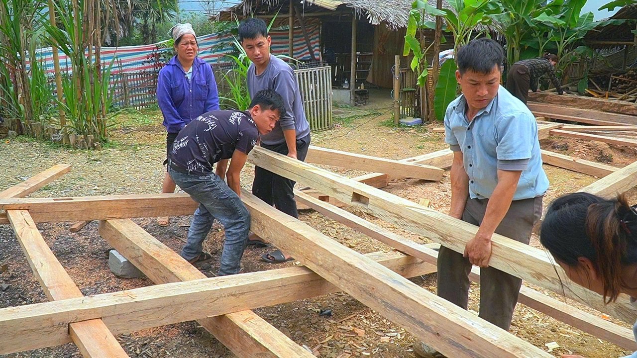 DAU & PHIN, along with their neighbors, came together to help DAN build a new wooden house.