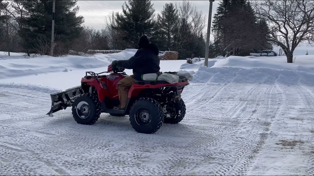 Polaris 450 HO plowing snow