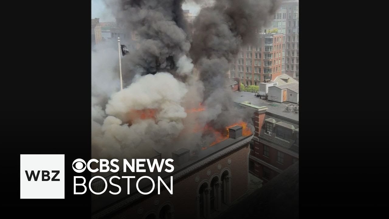 Firefighter working detail helps evacuate office building on fire in Downtown Boston
