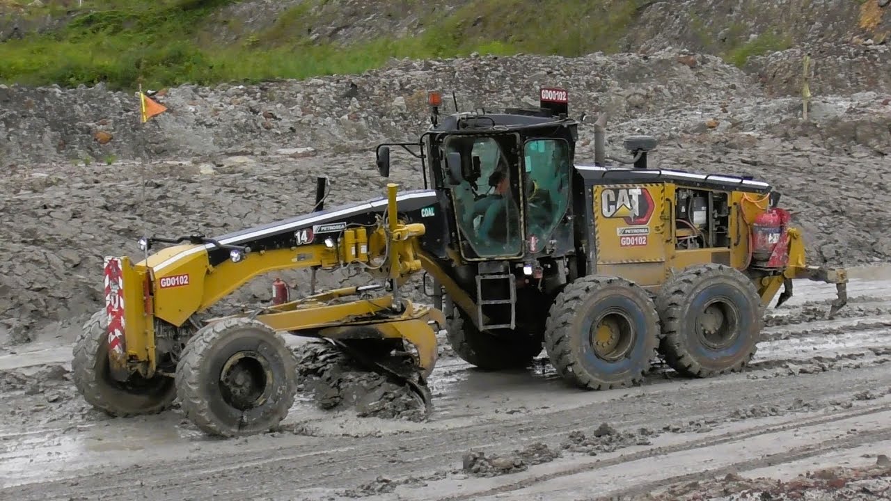 Motor Grader 14M3 Caterpillar Working On Wet Mine Roads