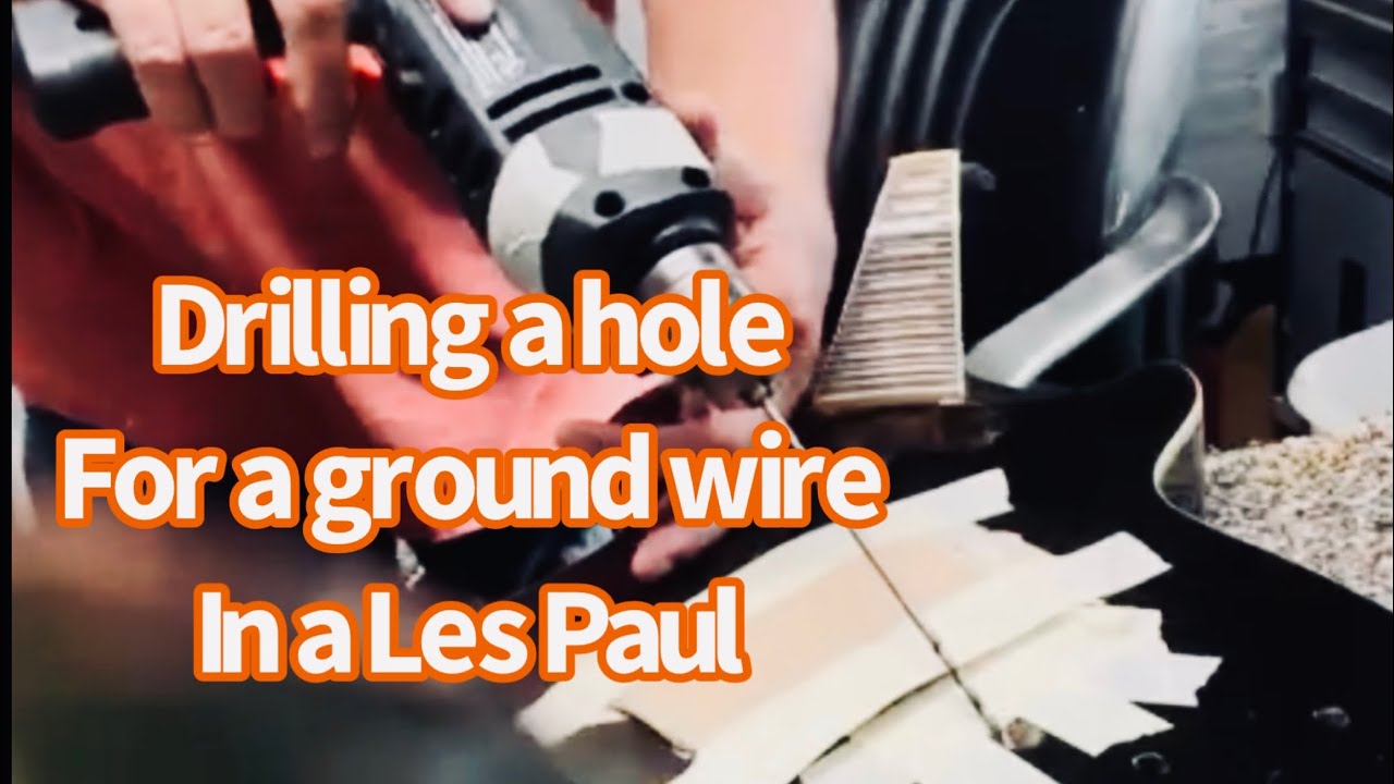 Drilling for a ground wire in a Les Paul style guitar with bridge and stop tailpiece.