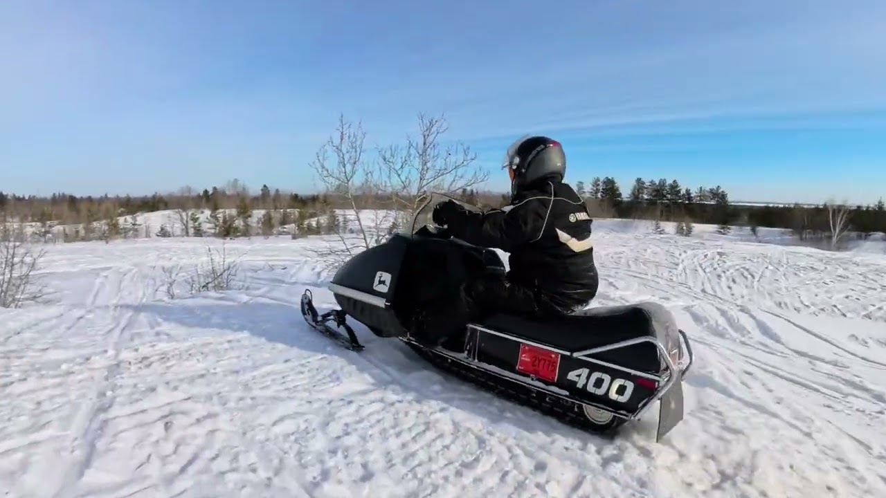 1995 Arctic Cat Puma and two 1975 John Deere snowmobiles having fun in the snow 