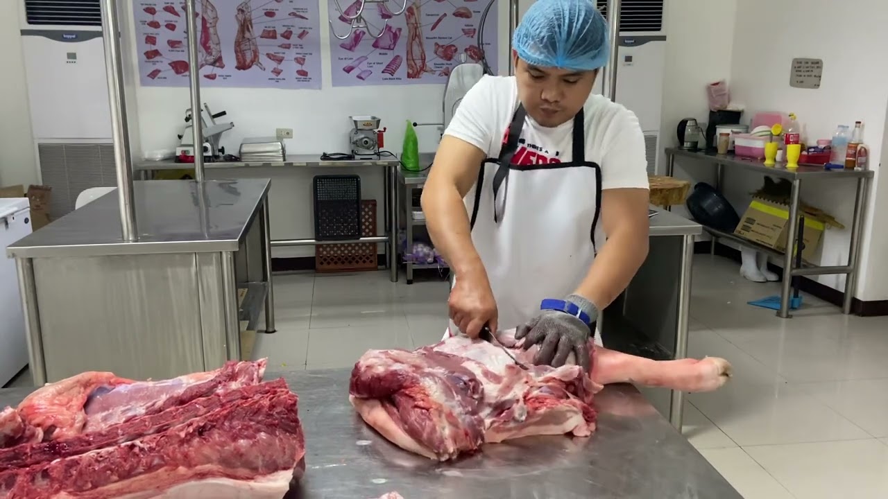 Ronald deboning a half carcass of pork