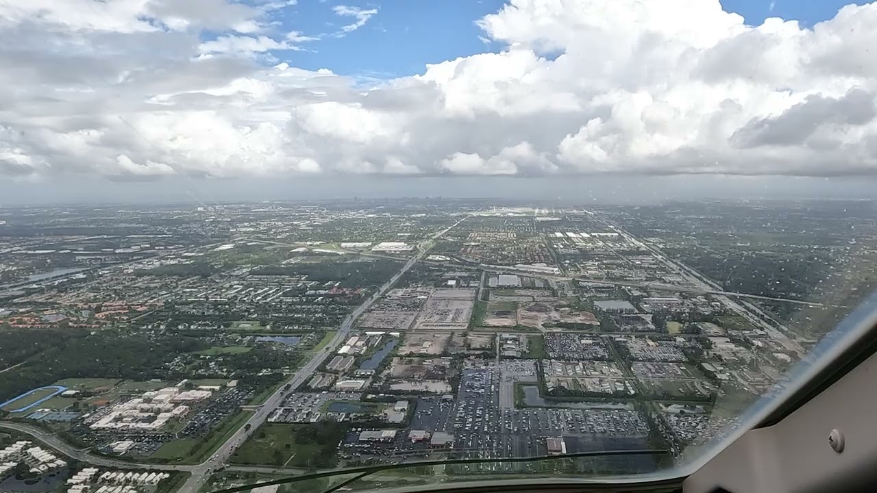 Bombardier Challenger 350 Landing PBI Rwy 10L (KLM) ILS approrach w/beautiful clouds & light rain.