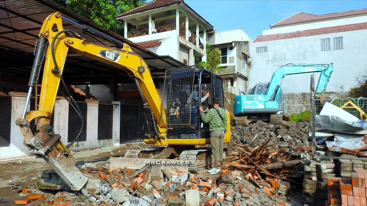 CAT & Kobelco Mini Excavator Collecting Rock Wall Debris for New Construction Work