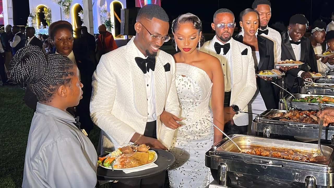 Congs! Baby Gloria & Jonas Mbaleka serve a wedding meal at their reception after  successful wedding