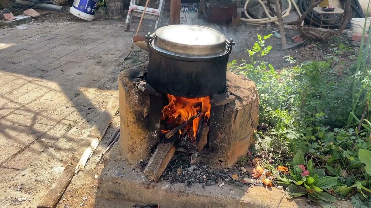 Cooking chicken over a wood fire; today is Lunar New Year's Eve