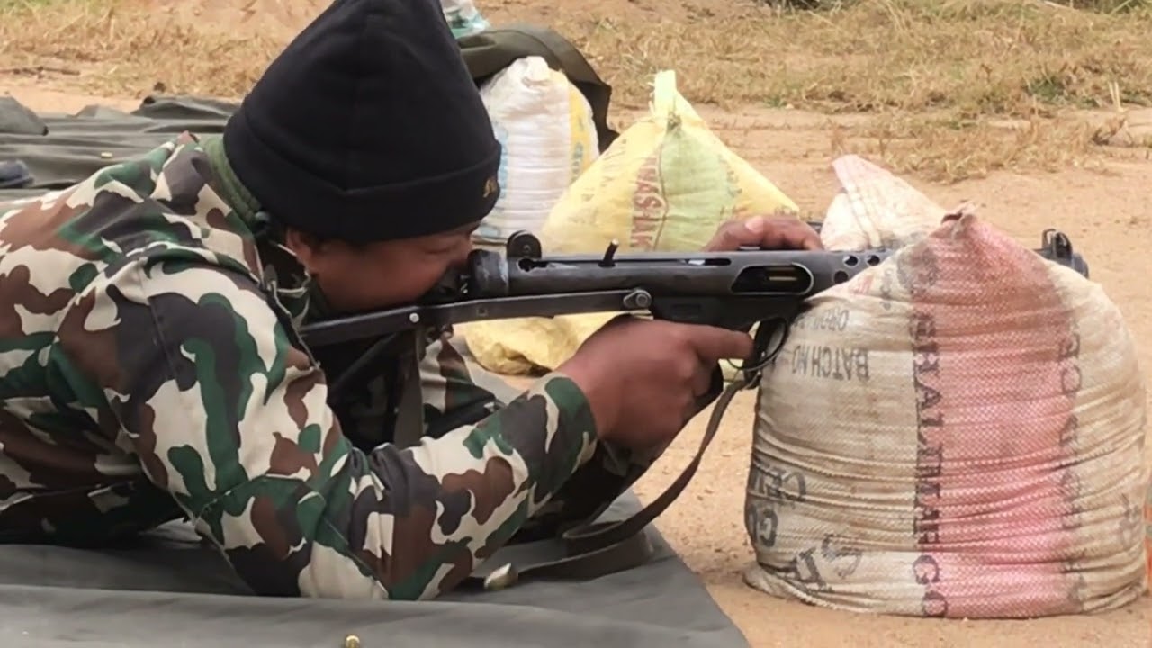 Military man Slowmo video of SMG gun Firing
