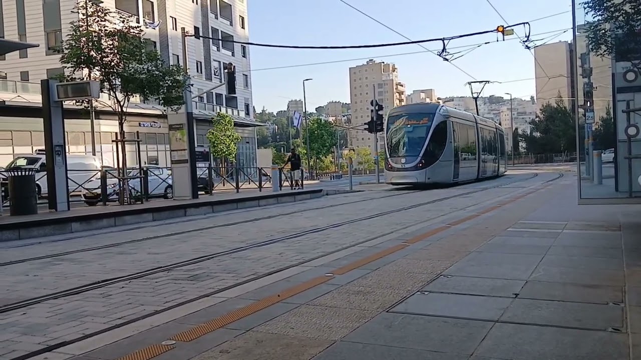 Jerusalem light rail Alstom Citadis 302 and CAF Urbos 100 trains at HaMifletzet Playground station