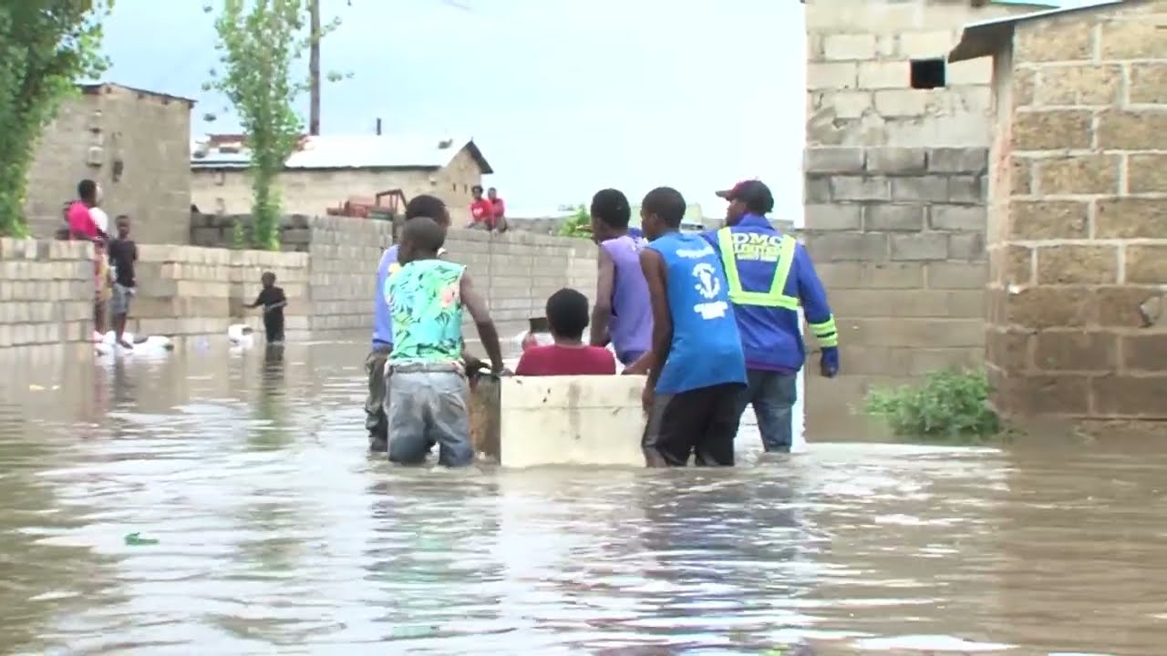 FLOODS SWEEP AWAY SON IN LUSAKA