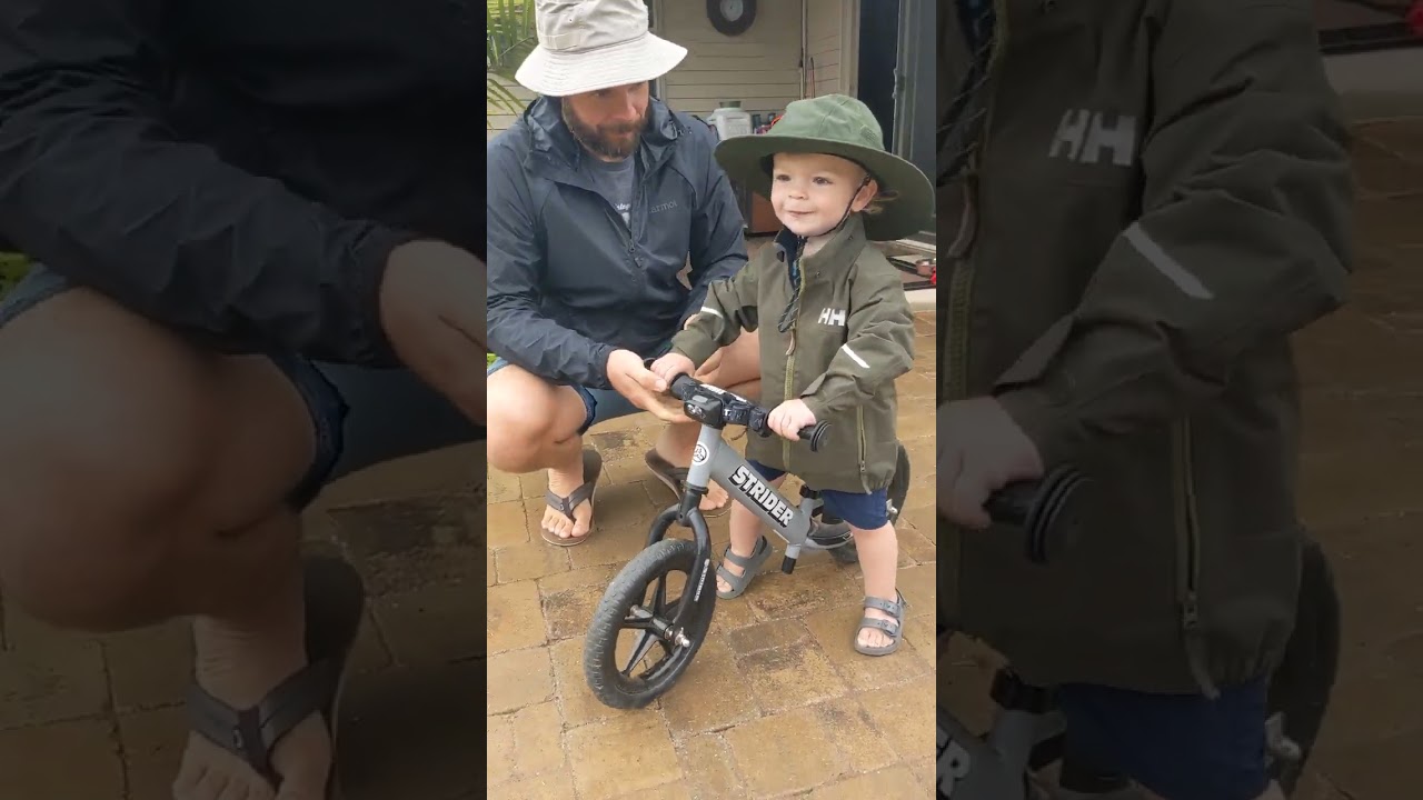 New rain gear, Elijah riding his bike 19 months old