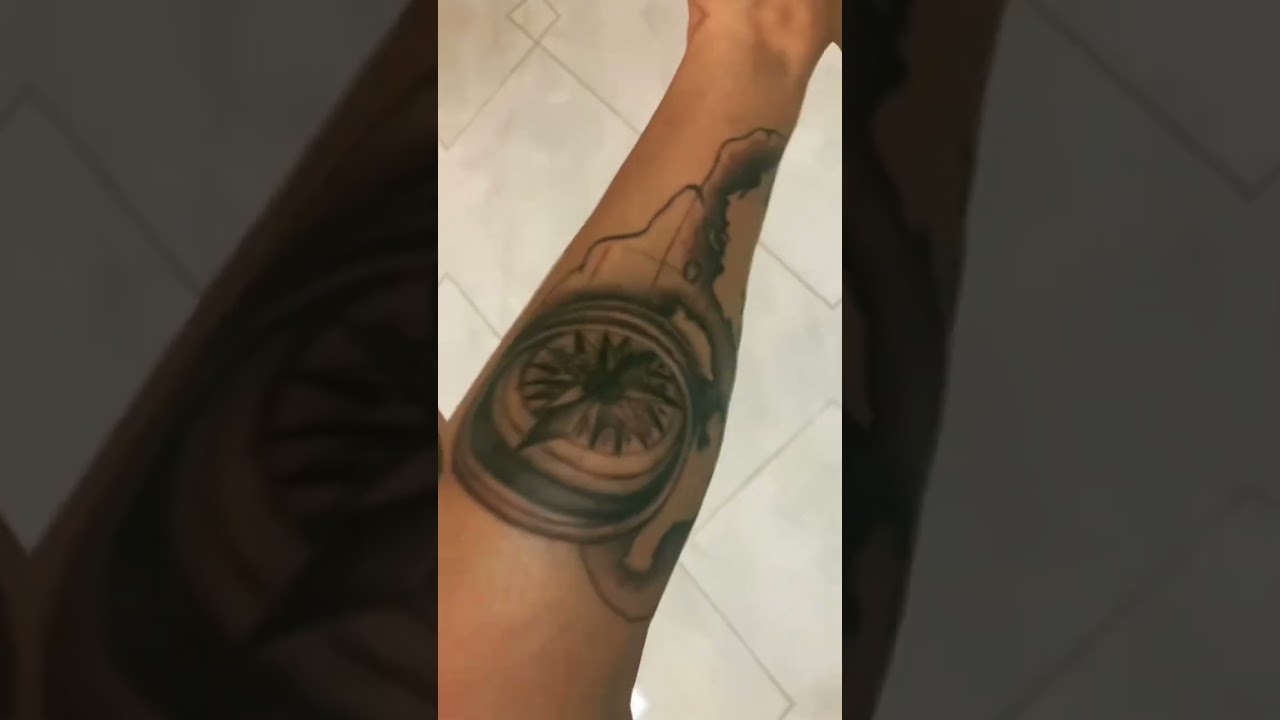 Compass and world map tattoo