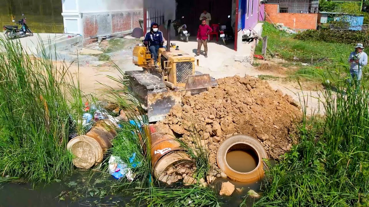 Start new project delete canal with bulldozer push soil filling the canal and dump truck cooperate