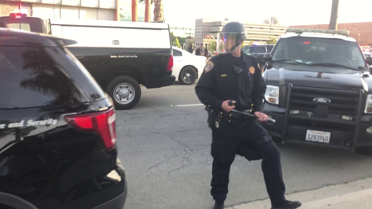 Walk past a group of officers and angry protesters