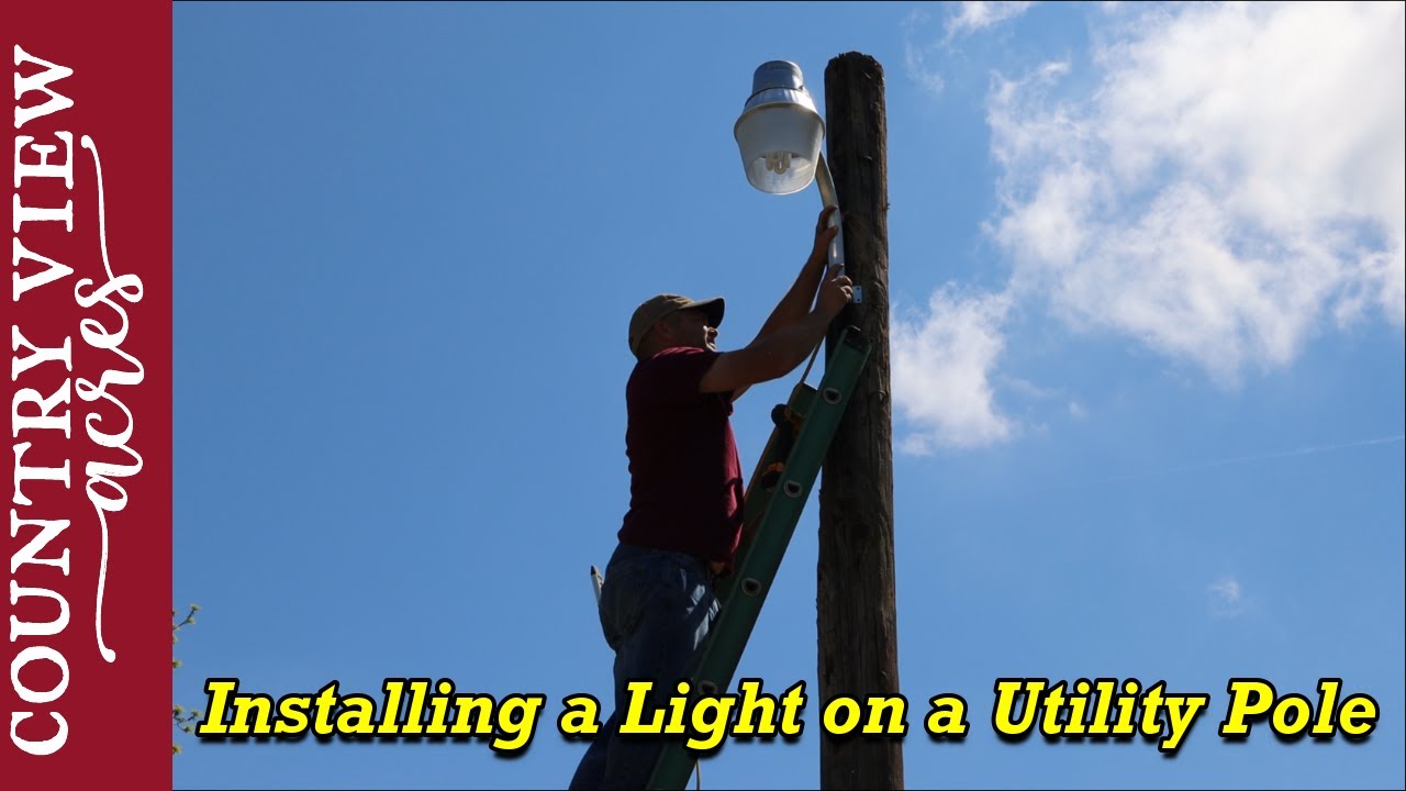 Installing a Light on a Utility Pole.   Lighting up the future equipment parking area.